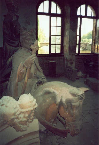 Statue removed from exterior of the Cathedral in Strasbourg being restored at the Fortress Bridge--watchtower bridge visible through the windows, photograph by C. W. Booth